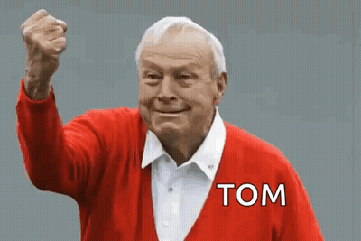 An Elderly Man In A Red Sweater With The Word Tom On It GIF