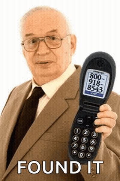 An Elderly Man In A Suit And Tie Is Holding A Flip Phone With A Phone Number On It . GIF