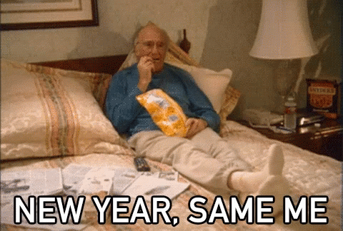 An Elderly Man Is Laying On A Bed Eating Chips With The Words New Year Same Me Above Him GIF