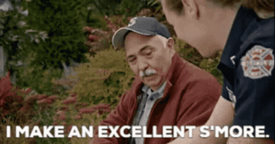 An Elderly Man Is Talking To A Firefighter Who Says I Make An Excellent S'more GIF