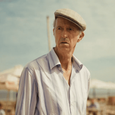 An Elderly Man Wearing A Hat And A Striped Shirt GIF