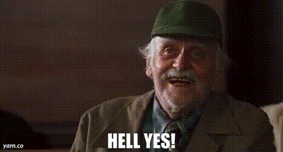 An Elderly Man Wearing A Hat And A Suit Is Smiling And Saying `` Hell Yes '' . GIF
