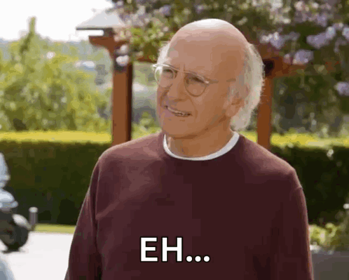 An Elderly Man Wearing Glasses And A Maroon Sweater Is Smiling And Saying Eh . GIF