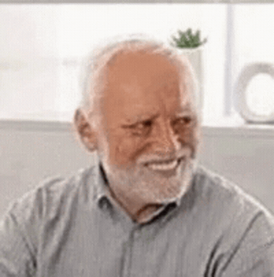 An Elderly Man With A Beard Is Smiling And Looking At The Camera . GIF