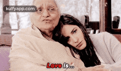 An Elderly Woman And A Young Woman Are Sitting Next To Each Other . GIF
