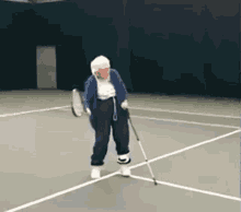 An Elderly Woman Holding A Tennis Racquet On A Tennis Court GIF