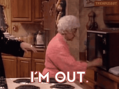 An Elderly Woman In A Pink Robe Is Standing In Front Of A Microwave And Says " I 'M Out " GIF