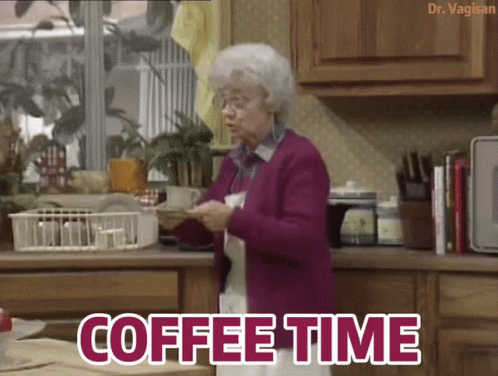 An Elderly Woman In A Purple Sweater Is Standing In A Kitchen With The Words Coffee Time Below Her GIF