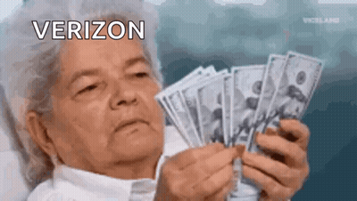 An Elderly Woman Is Holding A Bunch Of Money In Her Hands And Looking At It . GIF