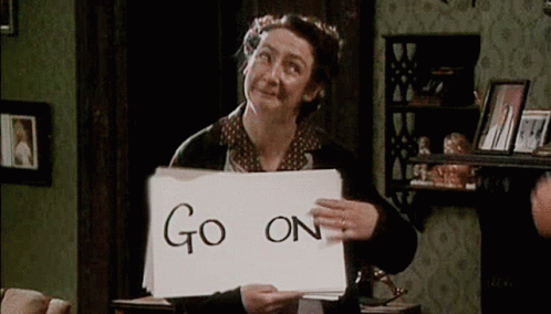 An Elderly Woman Is Holding A Piece Of Paper That Says Go On . GIF