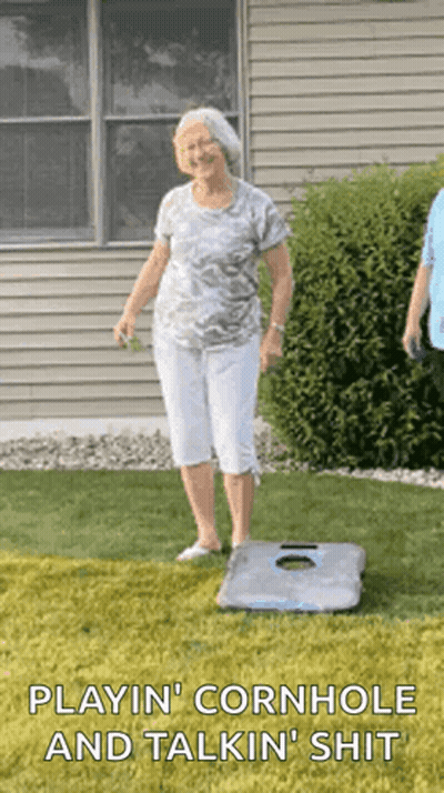 An Elderly Woman Is Playing Cornhole And Talking Shit GIF