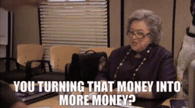 An Elderly Woman Is Sitting At A Desk Talking To Someone And The Words You Turning That Money Into More Money GIF