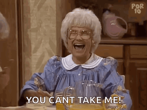 An Elderly Woman Is Sitting At A Table Laughing And Saying `` You Can T Take Me ! '' GIF