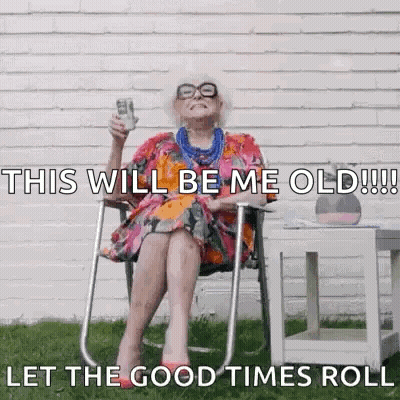 An Elderly Woman Is Sitting In A Chair Holding A Cup Of Coffee And A Bottle Of Beer . GIF