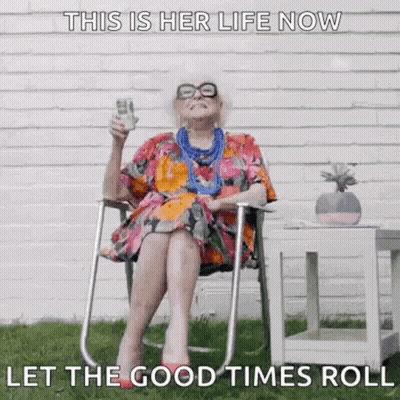 An Elderly Woman Is Sitting In A Chair Holding A Glass Of Wine And A Dollar Bill . GIF