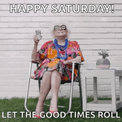 An Elderly Woman Is Sitting In A Folding Chair Holding A Glass Of Beer . GIF