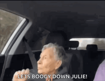 An Elderly Woman Is Sitting In The Back Seat Of A Car And Shouting . GIF