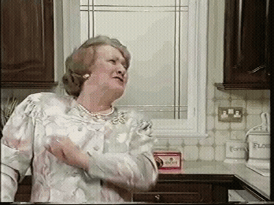 An Elderly Woman Is Standing In A Kitchen With A Box Of Flour On The Counter GIF
