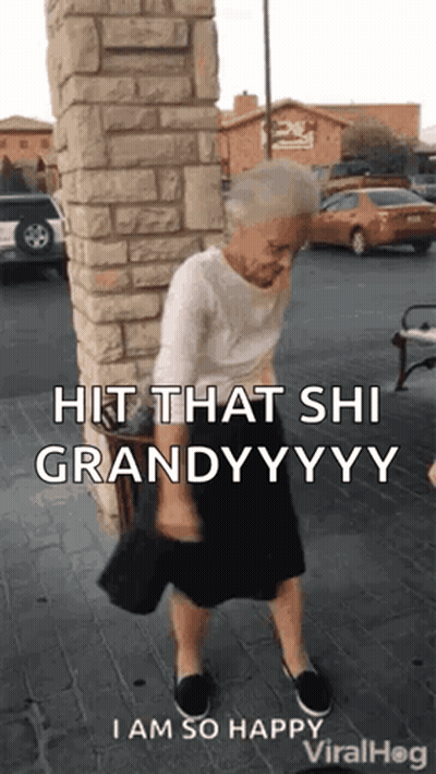 An Elderly Woman Is Standing In Front Of A Brick Wall Holding A Purse . GIF