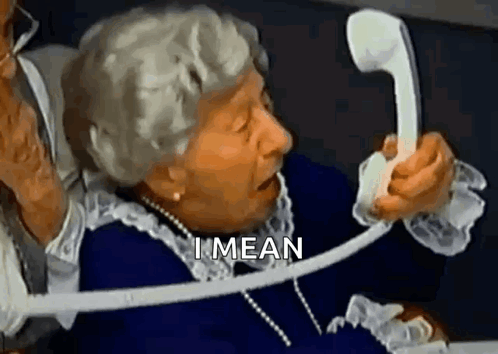 An Elderly Woman Is Talking On A Telephone With The Words `` I Mean '' Written Above Her . GIF
