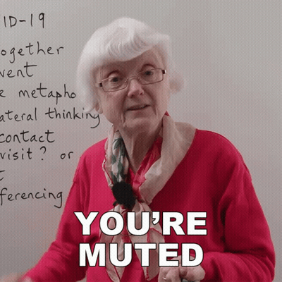An Elderly Woman Stands In Front Of A Whiteboard With The Words " You 'Re Muted " On It GIF