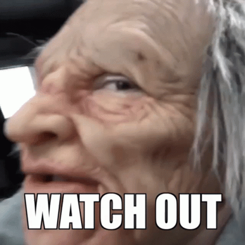 An Elderly Woman Wearing A Mask With The Words Watch Out Written On Her Face GIF