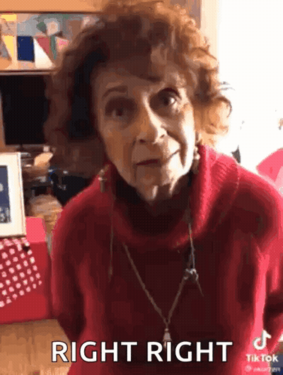 An Elderly Woman Wearing A Red Sweater Is Making A Funny Face And Says Right Right . GIF