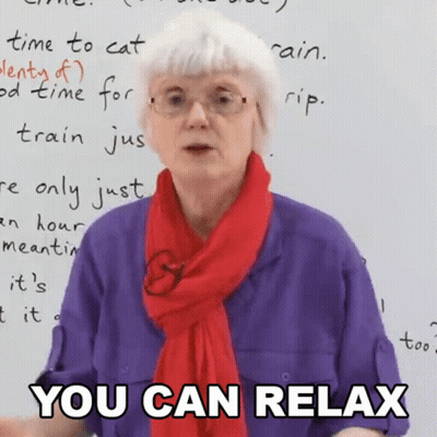 An Elderly Woman Wearing Glasses And A Red Scarf Says " You Can Relax " GIF