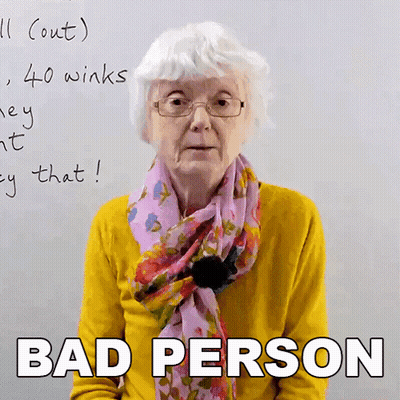 An Elderly Woman Wearing Glasses And A Scarf Says Bad Person In Front Of A Whiteboard GIF