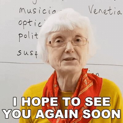 An Elderly Woman Wearing Glasses And A Scarf Says I Hope To See You Again Soon GIF