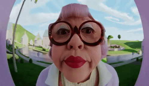 An Elderly Woman Wearing Glasses And Red Lipstick GIF