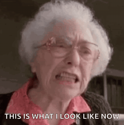 An Elderly Woman With White Hair And Glasses Is Making A Funny Face And Saying `` This Is What I Look Like Now '' . GIF