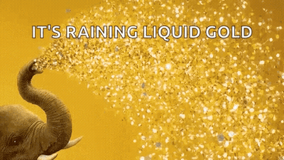 An Elephant Is Spraying Gold Confetti With Its Trunk . GIF