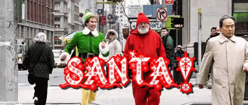 An Elf And A Santa Walking Down A Street GIF
