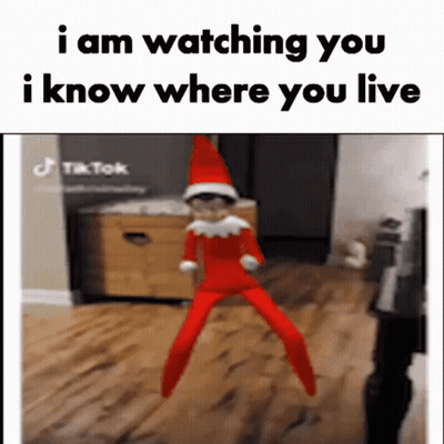 An Elf On The Shelf Is Jumping In The Air And Says `` I Am Watching You I Know Where You Live '' GIF