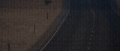 An Empty Highway With A Yellow Flag On The Side GIF