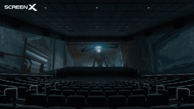 An Empty Movie Theater With A Screen X Logo Behind It GIF