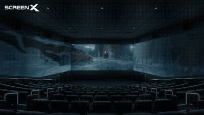 An Empty Movie Theater With A Screen X Logo In The Corner GIF