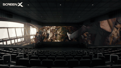 An Empty Movie Theater With A Screen X Logo On The Top GIF