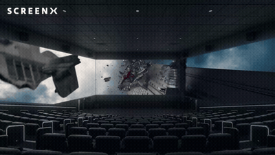 An Empty Movie Theater With A Screenx Logo On The Ceiling GIF