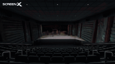 An Empty Movie Theater With The Screen X Logo On The Ceiling GIF