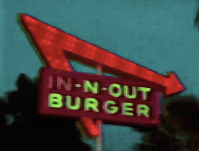 An In-N-Out Burger Sign With A Red Arrow GIF