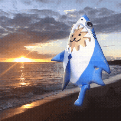 An Inflatable Shark With A Sun In Its Mouth Is Standing On A Beach GIF