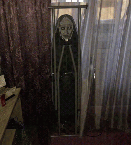 An Ironing Board With A Nun On It GIF