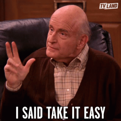 An Old Man Sitting In A Chair With The Words I Said Take It Easy Written Below Him GIF