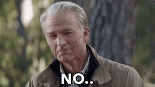 An Older Man In A Brown Jacket Is Standing In Front Of A Tree And Saying No . GIF