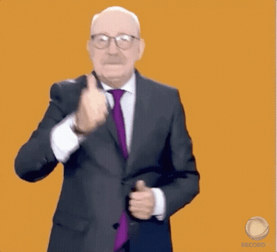 An Older Man In A Suit And Tie Is Dancing In Front Of An Orange Background GIF