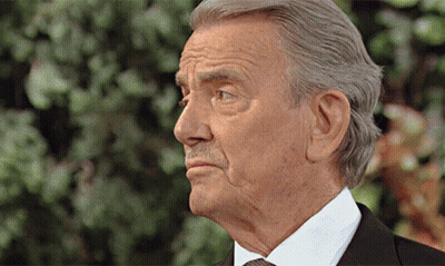An Older Man In A Suit And Tie Is Looking To The Side GIF