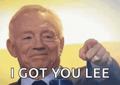 An Older Man In A Suit And Tie Is Pointing At The Camera . GIF