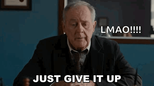 An Older Man In A Suit And Tie Is Sitting At A Desk And Says Lmao Just Give It Up GIF